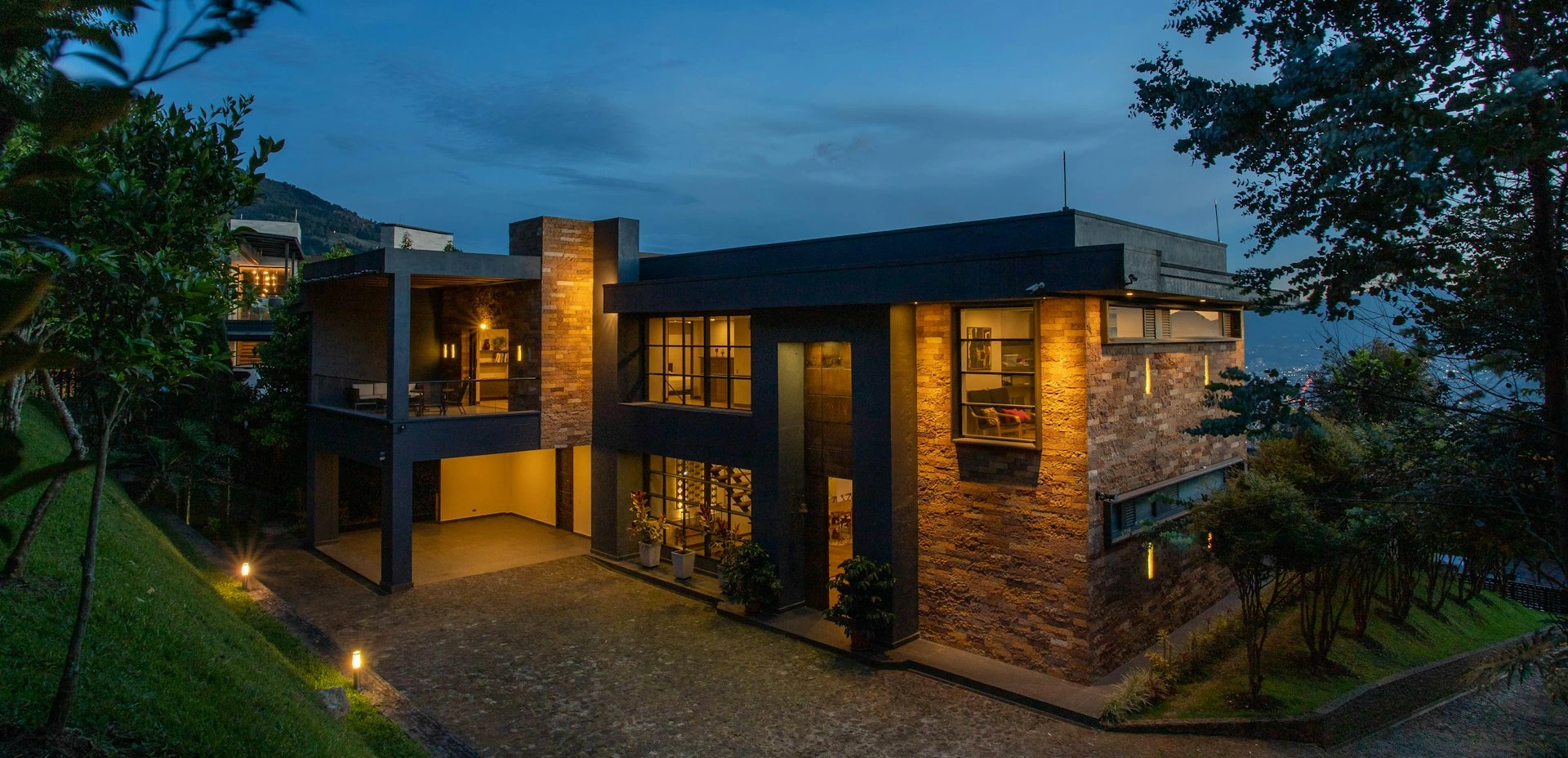 a house with a lot of windows lit up at night